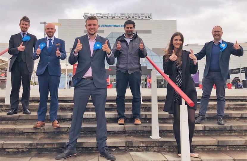 Conservative candidates give a thumbs up outside the Counting centre at ExCel